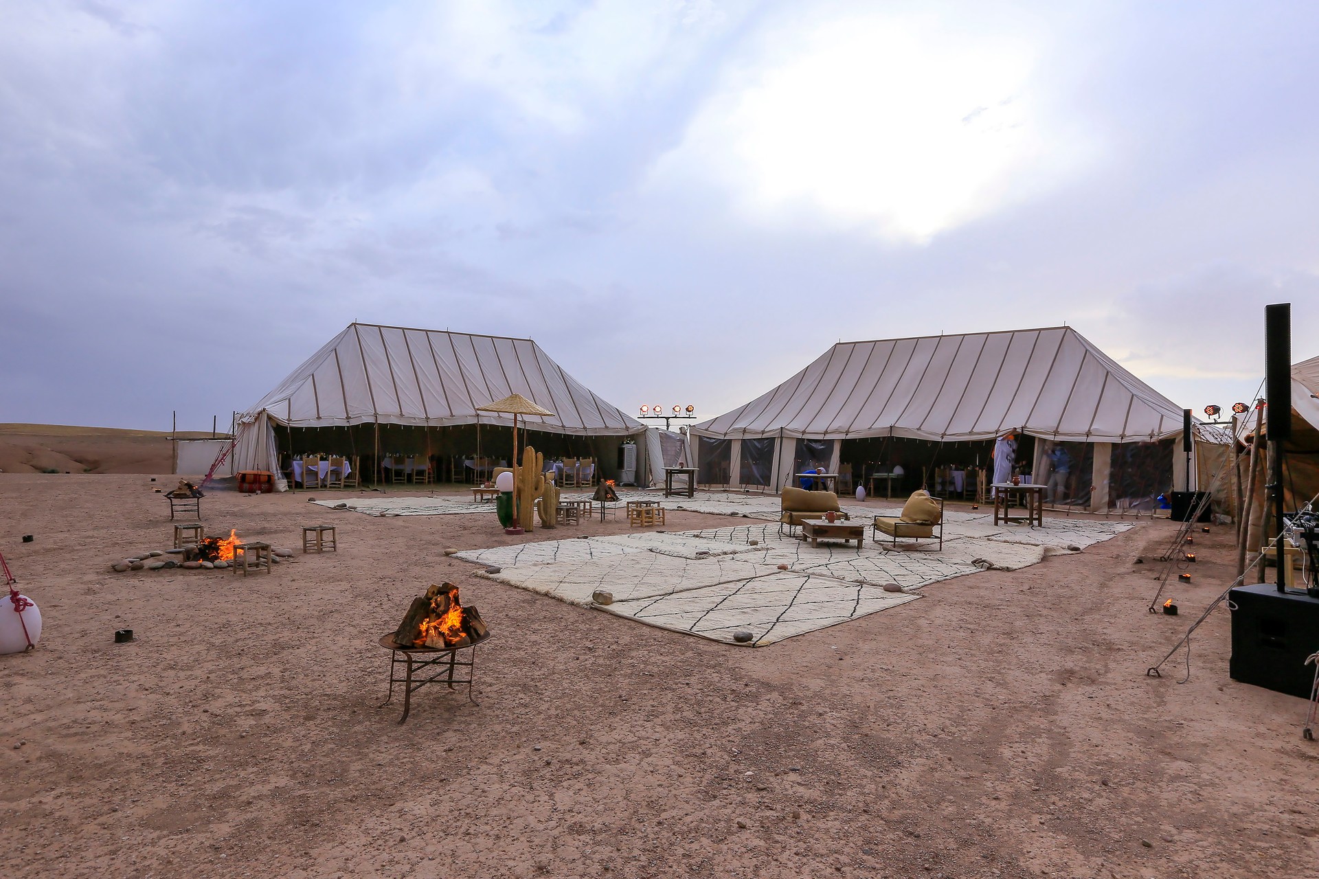 view of a glamping site at sunset in the Agafay Desert, near Marrakesh in Morocco